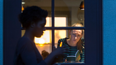 Oxy student reads at sunset at The Green Bean