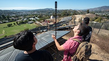 Students stand above Occidental’s solar array